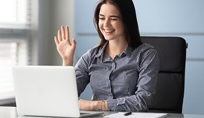 A student intern waving to a laptop screen.